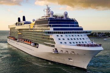 Big white modern cruiseship or cruise ship liner sail away departure from Key West, Florida during...