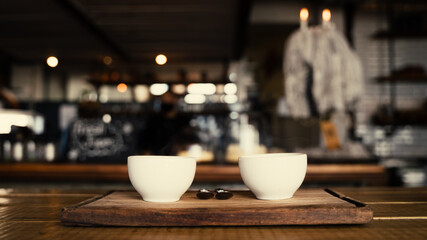 Portrait of two coffee cups freshly made and steaming on boards in trendy cafe