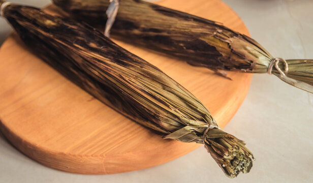 Brazilian traditional dessert. Bolo de tapioca (mane doido, pe de zumbi or pe de moleque nordestino similar to carim&atilde;, cassava cake). Brazilian cake made from tapioca flour, wrapped in banana leaves.
