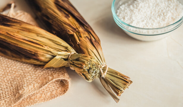 Brazilian traditional dessert. Bolo de tapioca (mane doido, pe de zumbi or pe de moleque nordestino similar to carim&atilde;, cassava cake). Brazilian cake made from tapioca flour, wrapped in banana leaves.