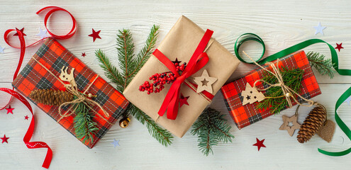 Christmas presents on a white wooden background. Banner. Flatlay.
