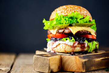 Beef burger.Fresh tasty burger on a black background.Hamburger.Delicious grilled angus burger with...