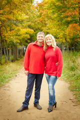 Middle-aged couple walking in the park on an autumn day.