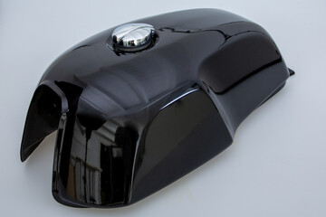 fuel tank black vintage caferacer on motorcycle with chrome cap over white background