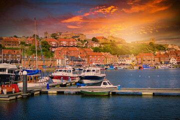 Whitby abbey is a seaside town and port at sunset in North Yorkshire, UK - obrazy, fototapety, plakaty