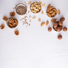 Fototapeta na wymiar Assorted of nuts on a white background. Space for text, top view