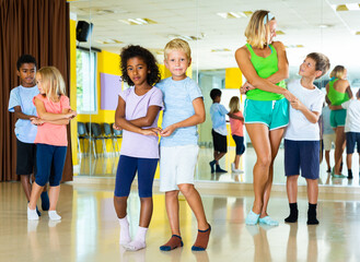Little boys and girls dancing pair dance in the ballet studio. High quality photo