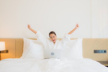 Portrait beautiful young asian woman use computer laptop on bed