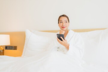 Portrait beautiful young asian woman use smart mobile phone on bed