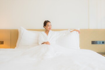 Portrait beautiful young asian woman smile relax leisure on bed