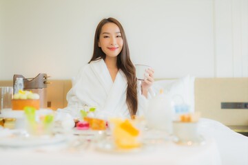 Obraz na płótnie Canvas Portrait beautiful young asian woman enjoy with breakfast on bed
