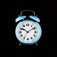 Classic table alarm clock light blue on a black background