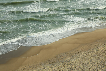 Sea with waves on beautiful sandy beach