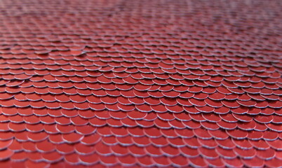 Red beautifully laid out sequins in the form of fish scales © NADEZHDA