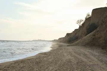 Sandy beach with clay slopes, space for text