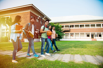 Education is fun - Cheerful Indian asian young students enjoying togetherness in college campus