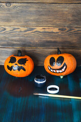 Funny pumpkins decorated with faces for the Halloween holiday. Celebrate a holiday with decorative pumpkins, copy space for text
