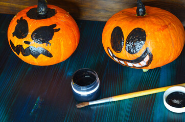 Funny pumpkins decorated with faces for the Halloween holiday. Celebrate a holiday with decorative...