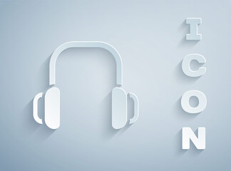 Paper cut Winter headphones icon isolated on grey background. Earmuffs sign. Paper art style. Vector.