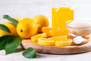 Fresh sweet multi-colored marmalade in sugar sprinkles in the form of slices on cutting board on table