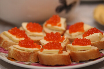 sandwiches with red caviar on the home table