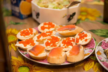 sandwiches with red caviar on the home table