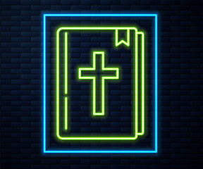 Glowing neon line Holy bible book icon isolated on brick wall background. Vector.