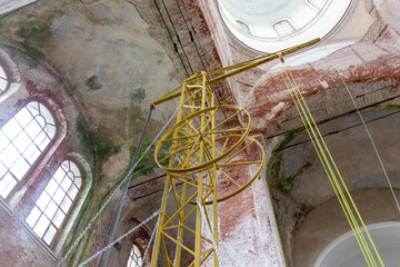 interior of the old abandoned and renovating brick church in russian village Sergeevo in day light