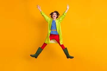Fototapeta na wymiar Full length photo portrait of girl jumping up spreading arms legs like star isolated on vivid yellow colored background