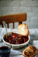 Tuscan style beef stew with toasted bread. style vintage
