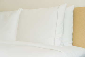 Fototapeta na wymiar White pillow and blanket on bed decoration interior