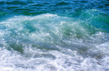 Fototapeta na wymiar Soft wave of sea on sandy beach. Background.