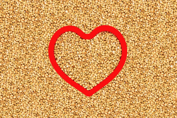 Green buckwheat groats in heart shape red frame