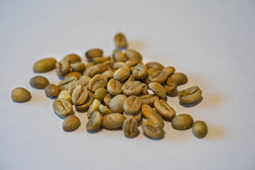 raw coffee beans are on a table.
