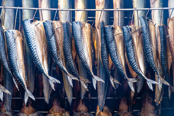 Dry smoked spiced mackerel in a smoker in a traditional market