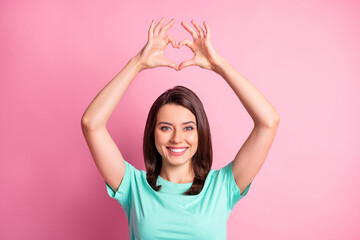 Fototapeta na wymiar Photo portrait of flirty girlfriend keeping hands in heart shape over head smiling isolated on pastel pink color background