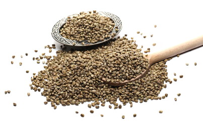 Hemp seeds pile with wooden spoon and decorative metal bowl isolated on white background