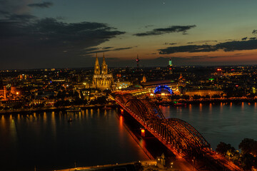 Fototapeta na wymiar Germany, Cologne, a large body of water with a city in the night sky
