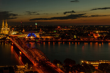 Germany, Cologne, a large body of water with a city in the night sky