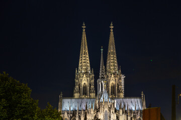 Fototapeta na wymiar Germany, Cologne, a clock tower lit up at night