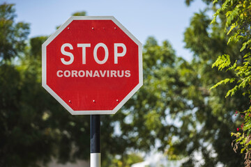 Photo of a stop sign giving awareness about Coronavirus
