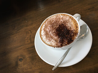 Close up white coffee cup  on dark wood table