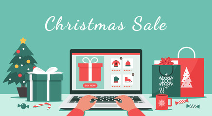 Christmas online shopping or winter holiday sale concept, human hand makes order on laptop screen with gift boxes, shopping bags on the desk, and text, vector flat illustration