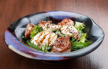 Duck breast salad with cream cheese and arugula. In a decorative plate