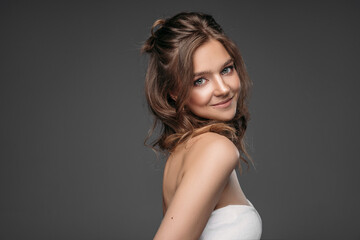 Fototapeta premium Portrait of a young woman isolated on gray background