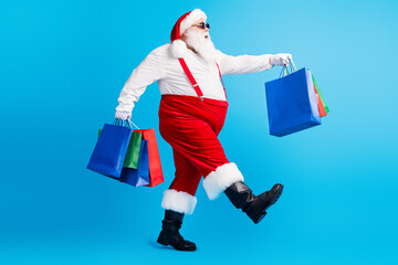 Full length photo of modern white grey hair bearded santa claus go shopping hold x-mas christmas...