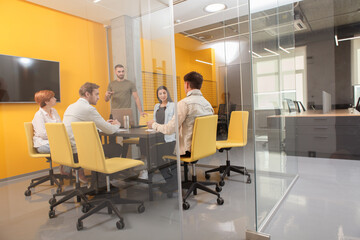 Creative team having business meeting at modern open space office, copy space
