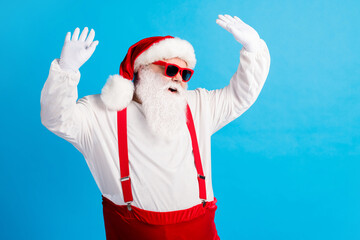 Photo of grandpa grey beard raise hands dance midnight disco wear santa claus x-mas costume suspenders sunglass white shirt headwear gloves isolated blue color background