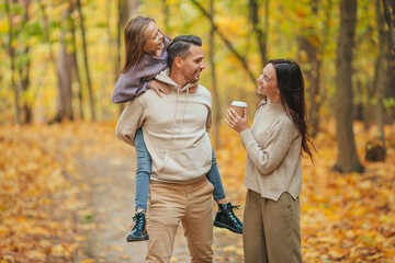 Fototapeta premium Portrait of happy family of three in autumn day