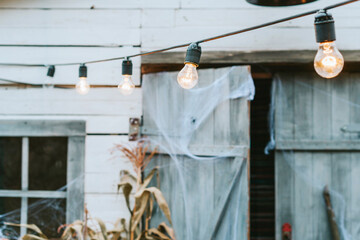 the porch is decorated with cobwebs and lights for Halloween